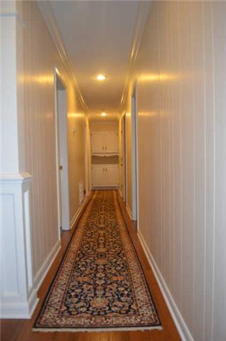 446 Belmont Road Manchester, TN 37355 - Photo 9 of 20 The hall leads you to the bedrooms & extra closet space. Notice the gorgeous hardwood flooring & cabinetry at the end of the hall providing additional storage.