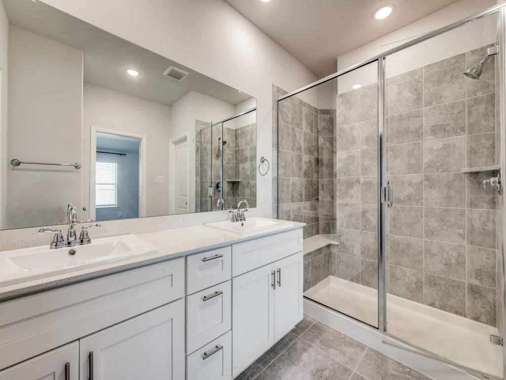 930 Waterview Drive Prosper, TX 75078 - Photo 15 of 17 a bathroom with a shower sink and mirror
