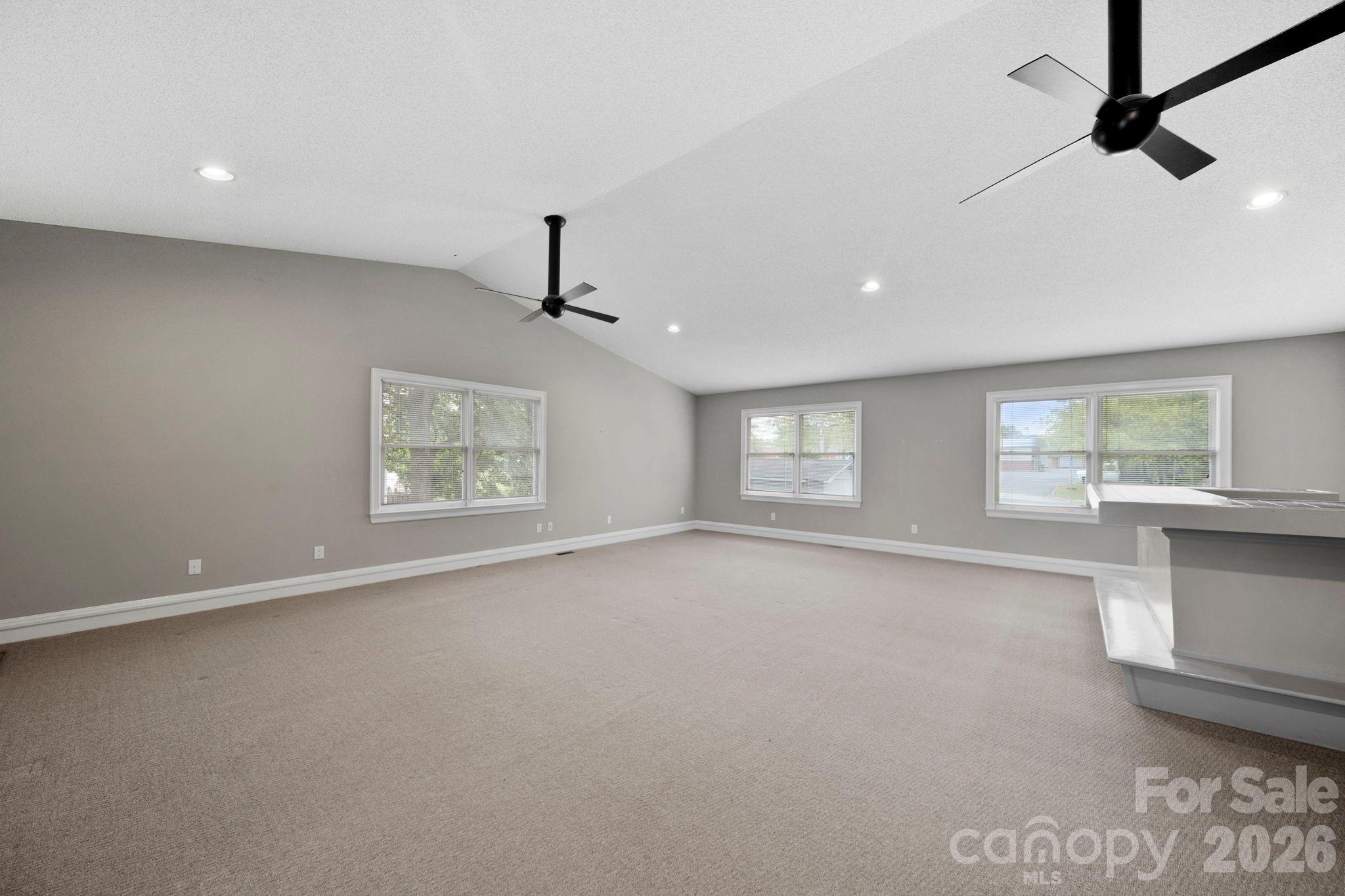 1109 Union Road Gastonia, NC 28054 - Photo 36 of 44 an empty room with windows and ceiling fan