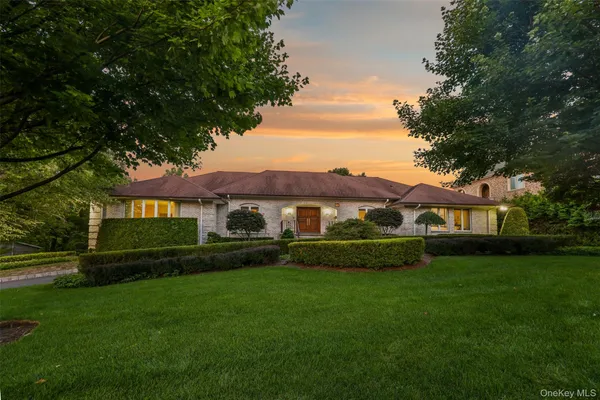 a front view of a house with a garden