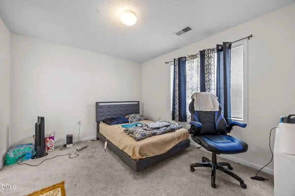 a bedroom with furniture and a chandelier
