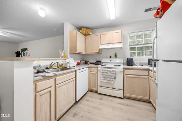 a kitchen with sink cabinets and window