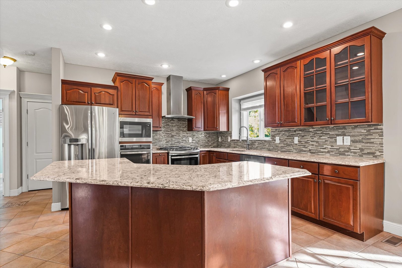 1 Windsong Way Bloomington, IL 61704 - Photo 12 of 90 a kitchen with stainless steel appliances granite countertop a sink and a refrigerator