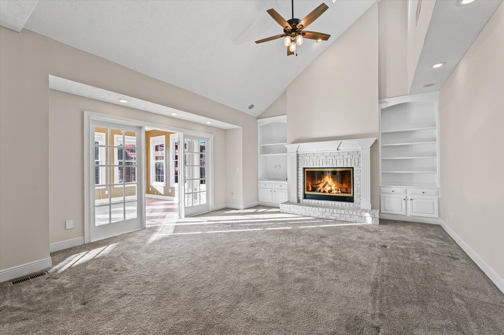 1 Windsong Way Bloomington, IL 61704 - Photo 19 of 90 a view of an empty room with a fireplace and a window