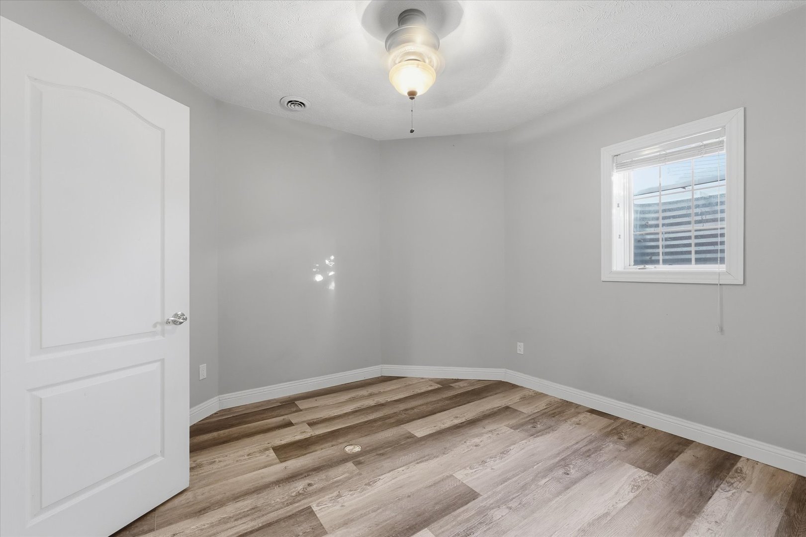 1 Windsong Way Bloomington, IL 61704 - Photo 67 of 90 a view of empty room with wooden floor and fan
