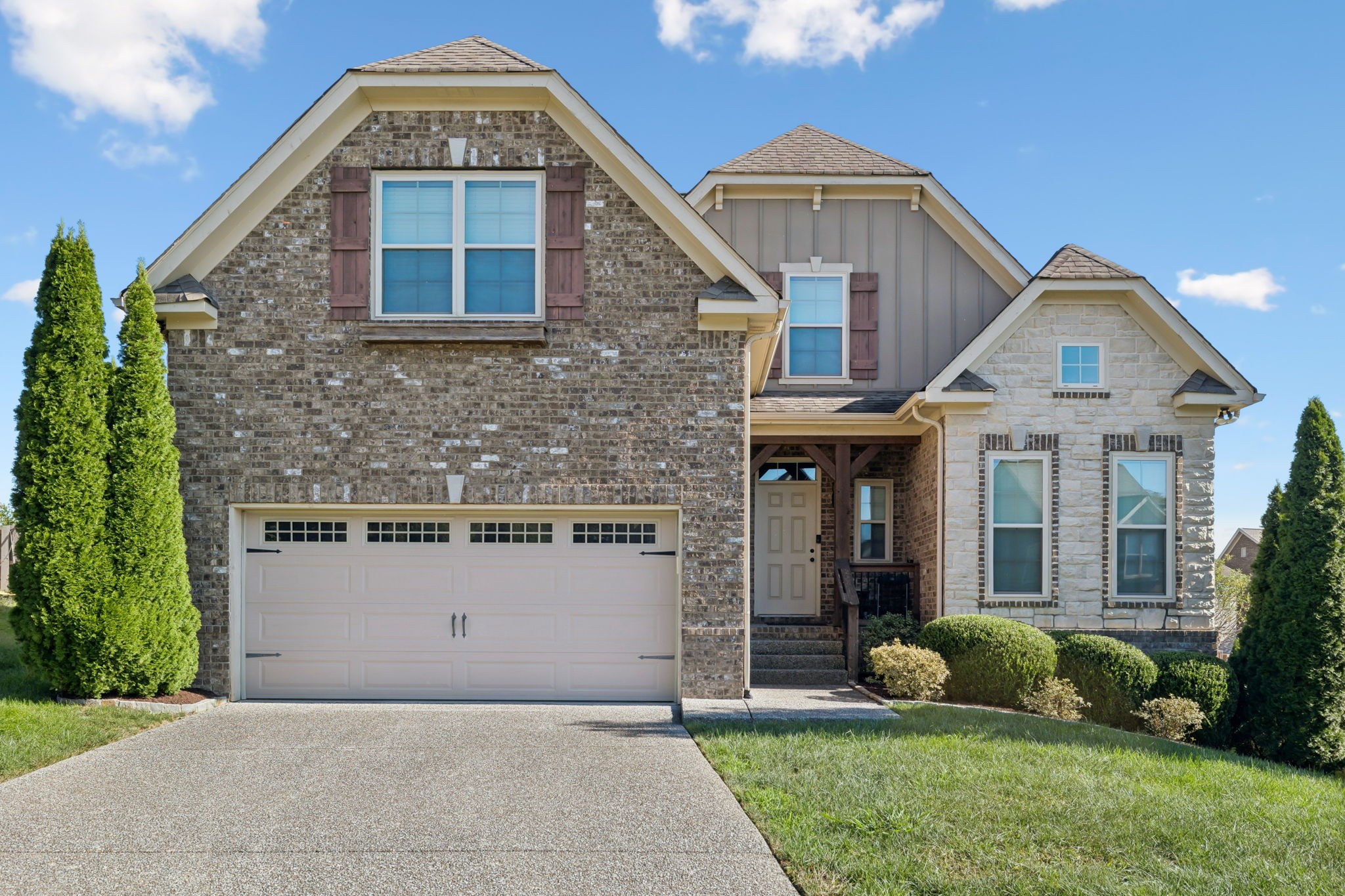 a front view of a house with garden