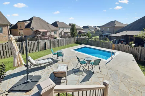 a view of a backyard with sitting area and furniture