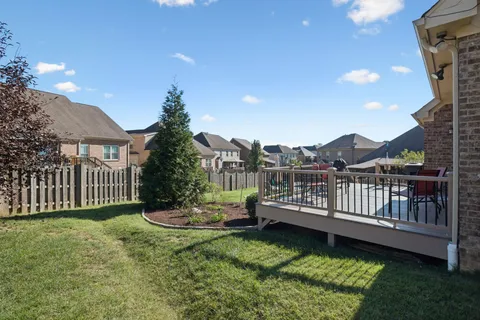 a view of a balcony with wooden floor and fence
