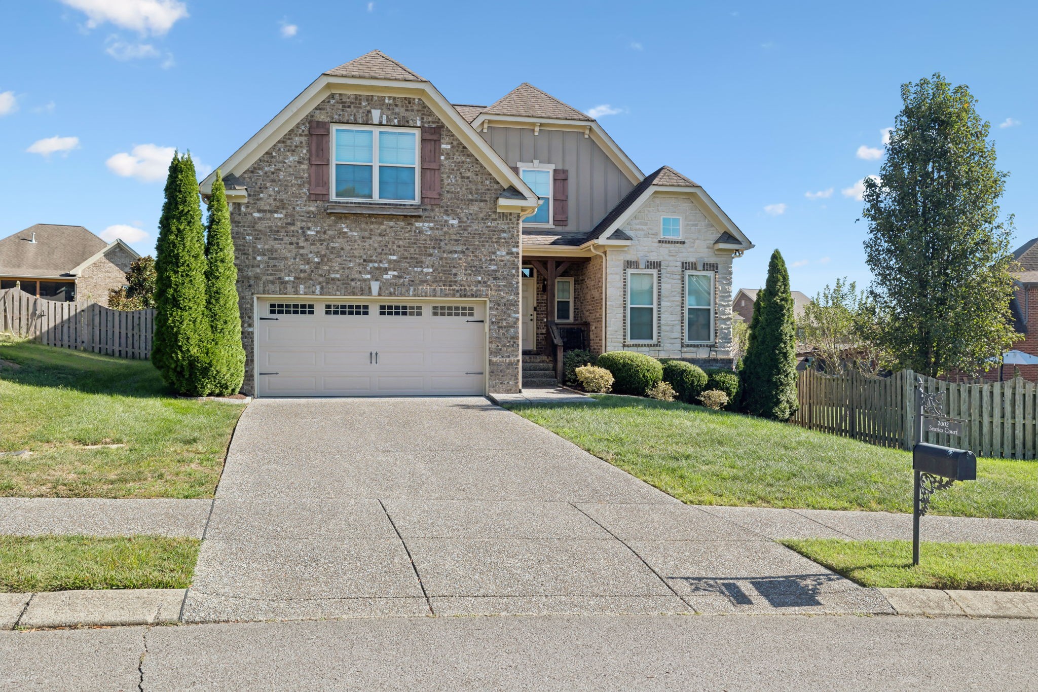 2002 Searles Court Spring Hill, TN 37174 - Photo 2 of 49 a front view of a house with a yard and garage