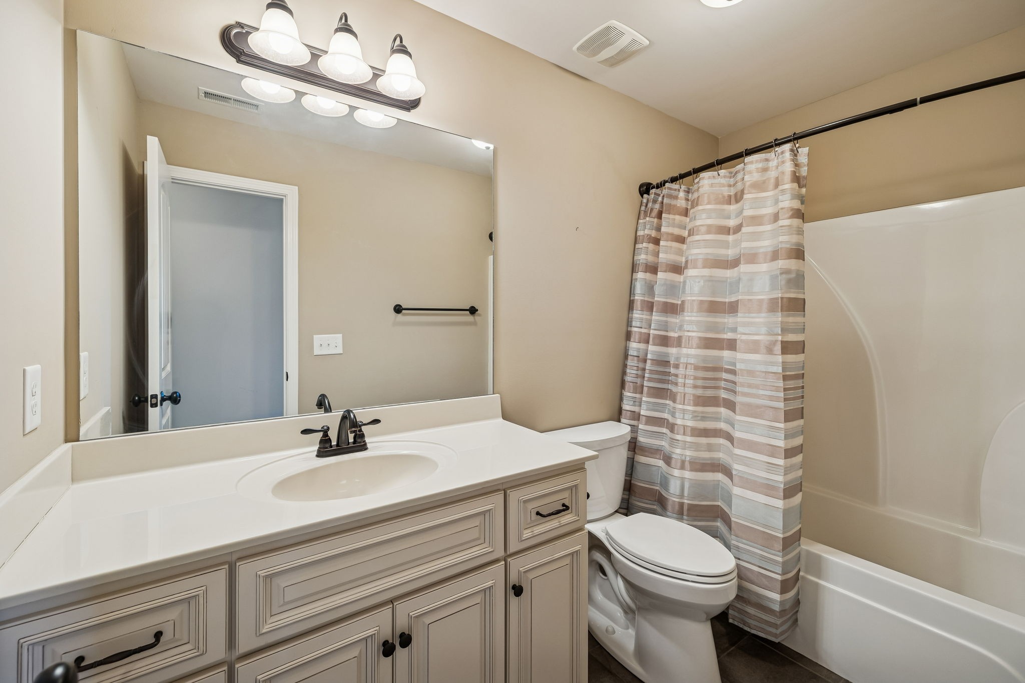 2002 Searles Court Spring Hill, TN 37174 - Photo 37 of 49 a bathroom with a sink a toilet a mirror and shower