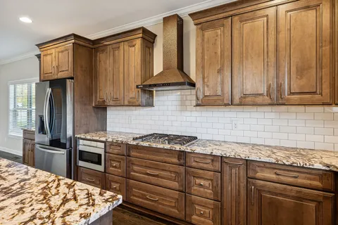 a living room with a fireplace and wooden floor