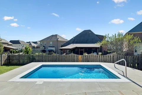 a view of a patio with a table and chairs