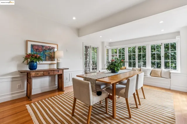 a kitchen with a table chairs sink and window