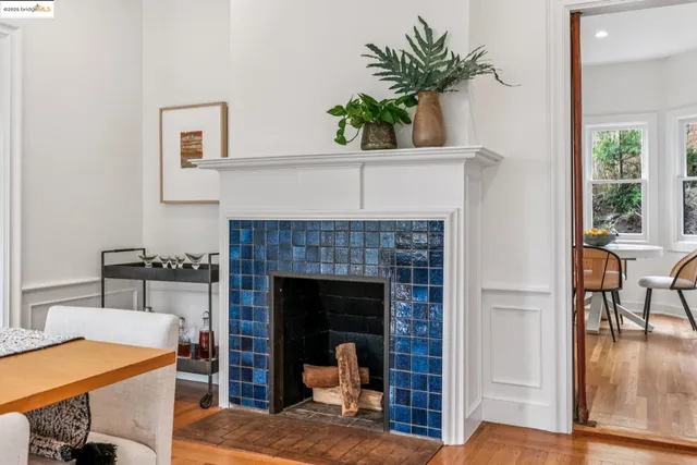 a open kitchen with furniture a fireplace and a large window