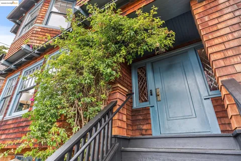 a view of balcony with wooden floor and fence and a potted plant