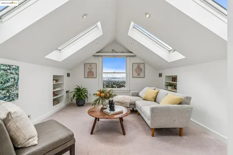 a kitchen with stainless steel appliances granite countertop a stove a sink dishwasher and white cabinets with wooden floor