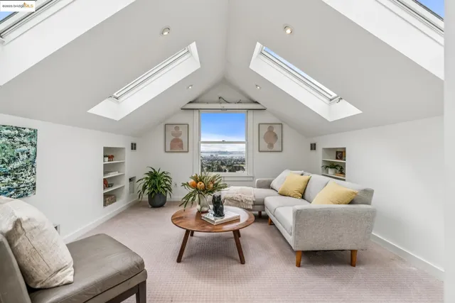 a kitchen with stainless steel appliances granite countertop a stove a sink dishwasher and white cabinets with wooden floor