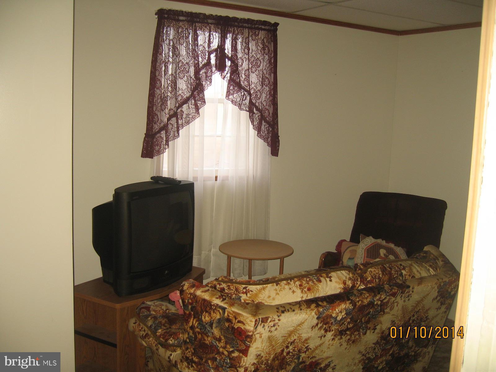 1518 Leslie Road Baltimore, MD 21222 - Photo 7 of 13 a bedroom with a bed and chair