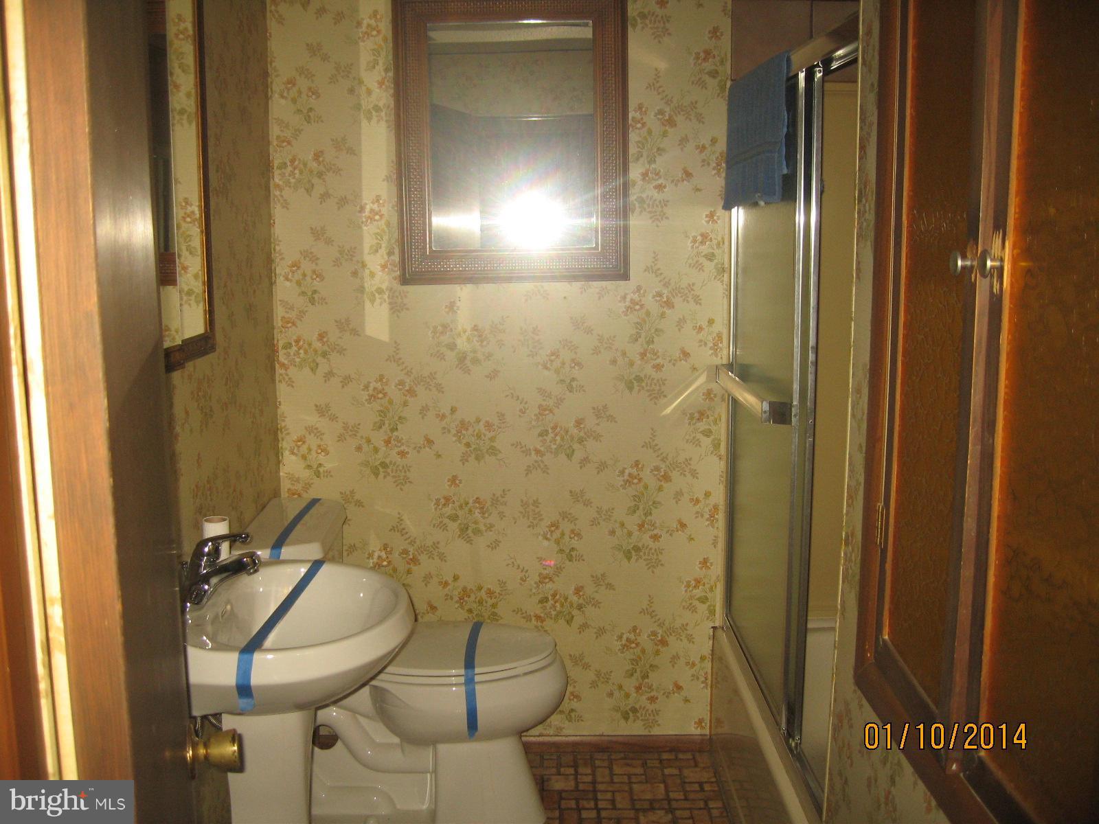 1518 Leslie Road Baltimore, MD 21222 - Photo 9 of 13 a bathroom with a sink and a mirror