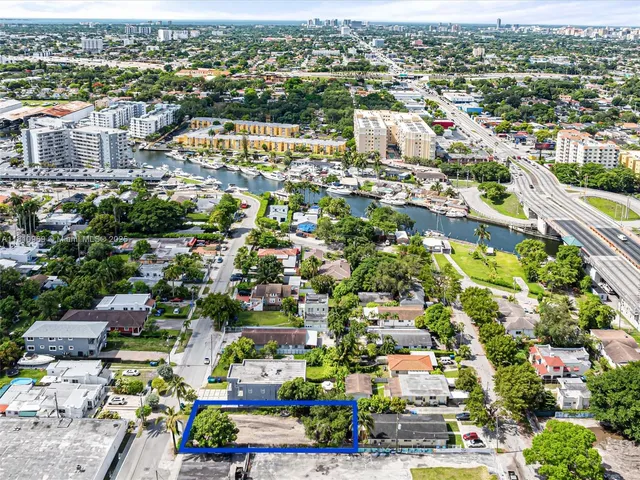 an aerial view of residential houses with city view