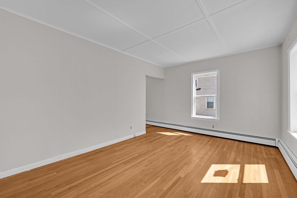 47 Morris Street Southbridge, MA 01550 - Photo 9 of 40 an empty room with wooden floor and windows