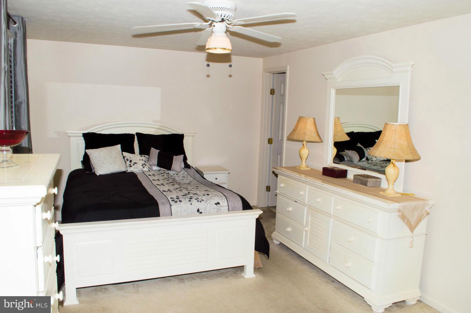 7817 Paddock Way Baltimore, MD 21244 - Photo 13 of 22 a bedroom with a bed and a chandelier
