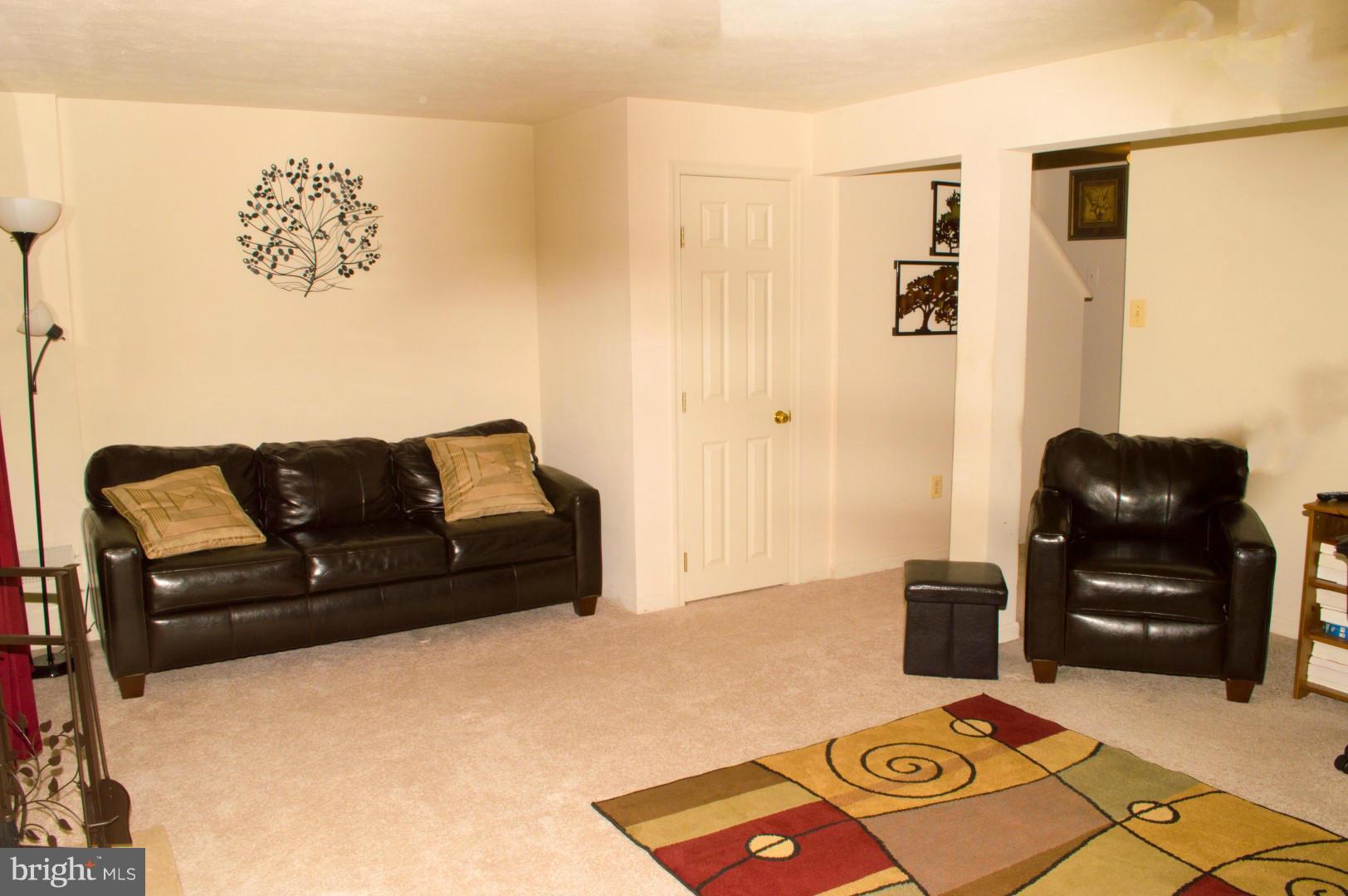 7817 Paddock Way Baltimore, MD 21244 - Photo 17 of 22 a living room with a couch and a piano