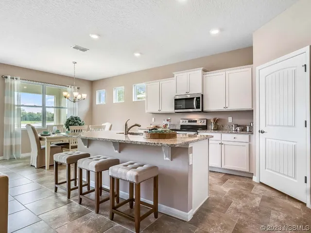 a kitchen with stainless steel appliances granite countertop a sink stove and microwave