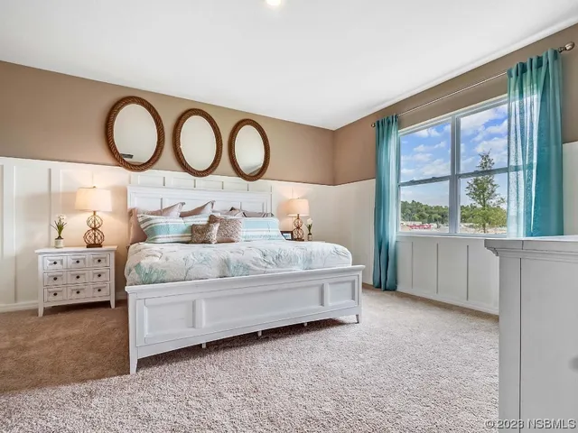 a bedroom with a large bed and a large window