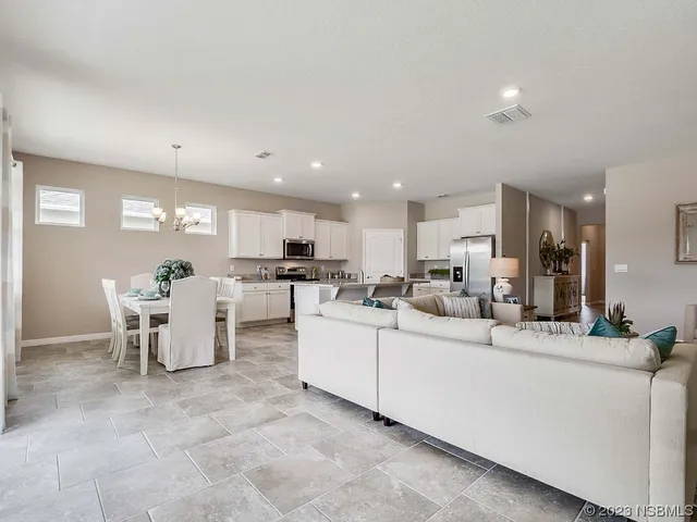 a view of a dining room with furniture window and chandelier
