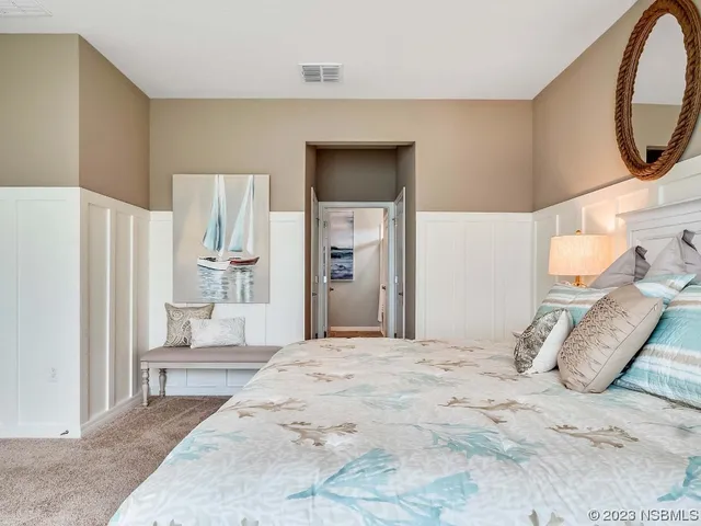 a bedroom with a bed and a mirror