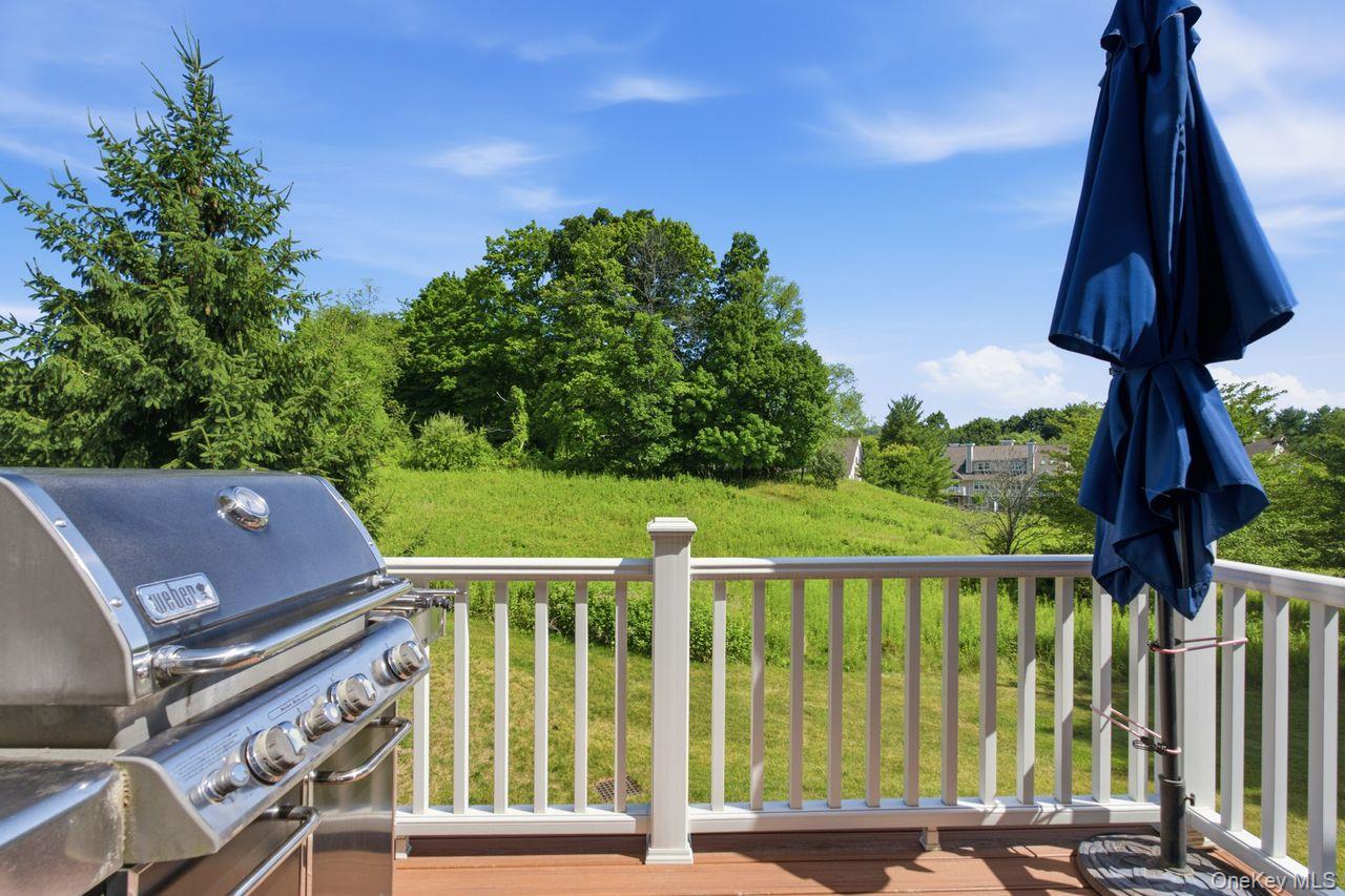 64 Roma Orchard Road Peekskill, NY 10566 - Photo 36 of 40 Spacious outdoor deck with composite decking, white railing system, and lush green landscaping