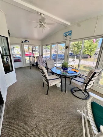 a room with furniture pool table and windows