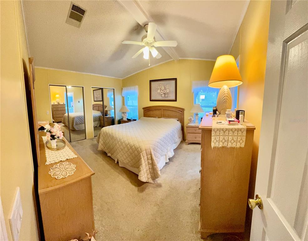 4372 Whiting Way Edgewater, FL 32141 - Photo 2 of 20 a bedroom with a bed and a lamp
