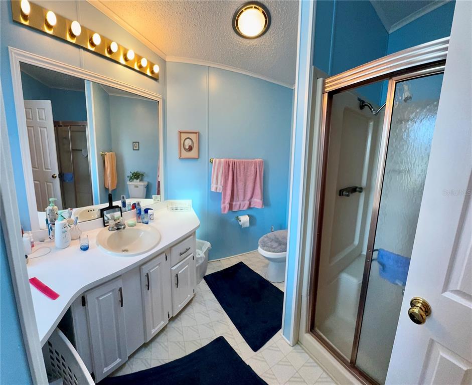 4372 Whiting Way Edgewater, FL 32141 - Photo 3 of 20 a bathroom with a sink and a mirror