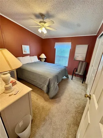 a bedroom with double bed and a chandelier