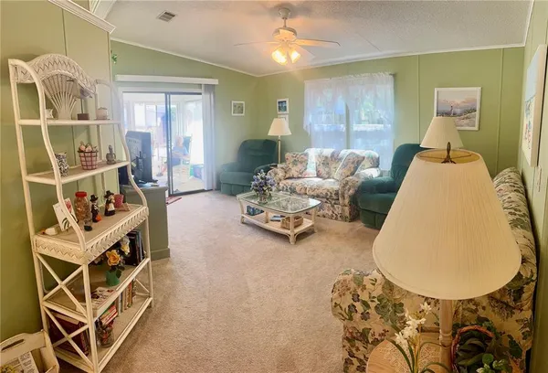 a living room with furniture and a floor to ceiling window