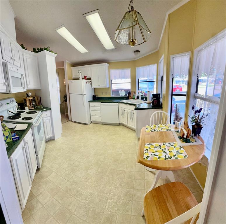 4372 Whiting Way Edgewater, FL 32141 - Photo 10 of 20 a kitchen with stainless steel appliances granite countertop a sink and cabinets