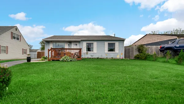 a front view of house with yard and green space