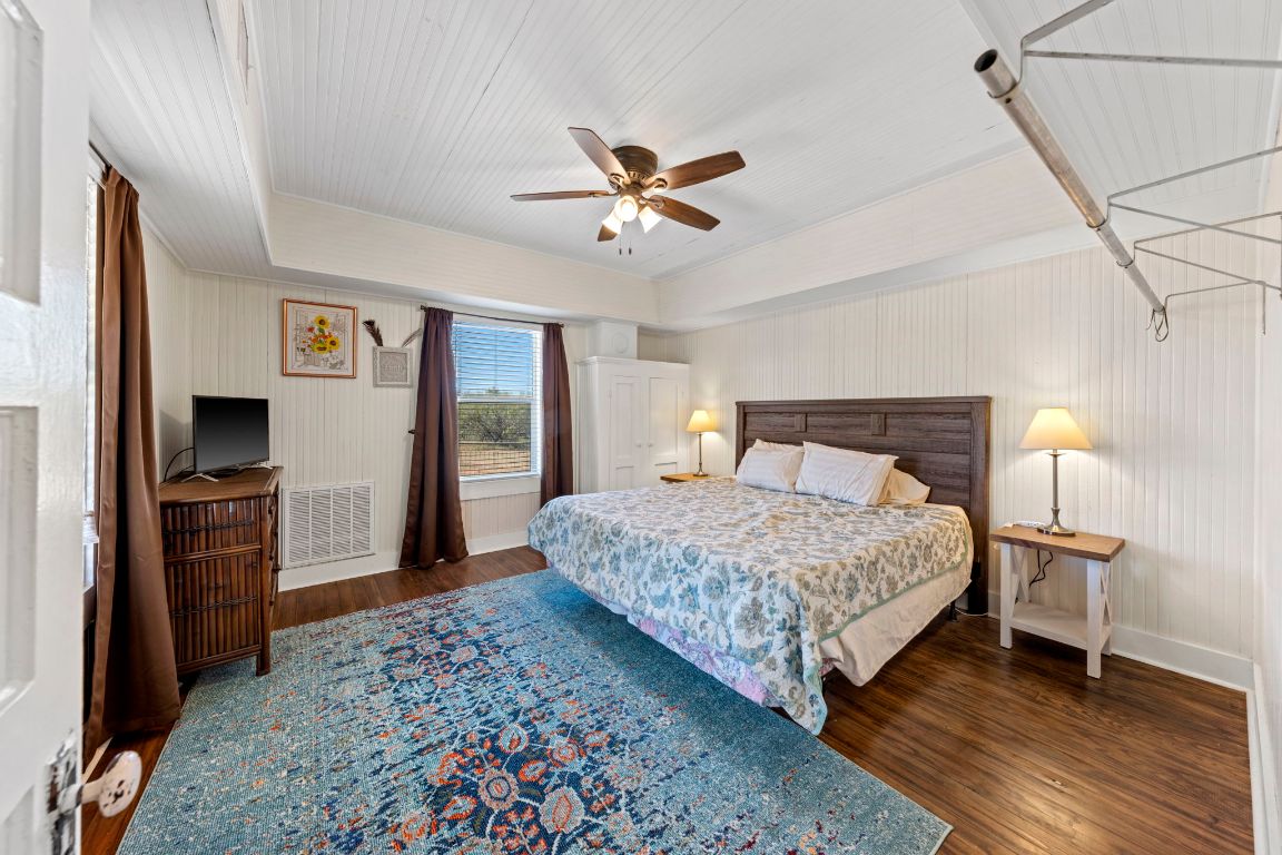 527 Walter Road Fredericksburg, TX 78624 - Photo 19 of 39 a bedroom with a bed and a flat screen tv