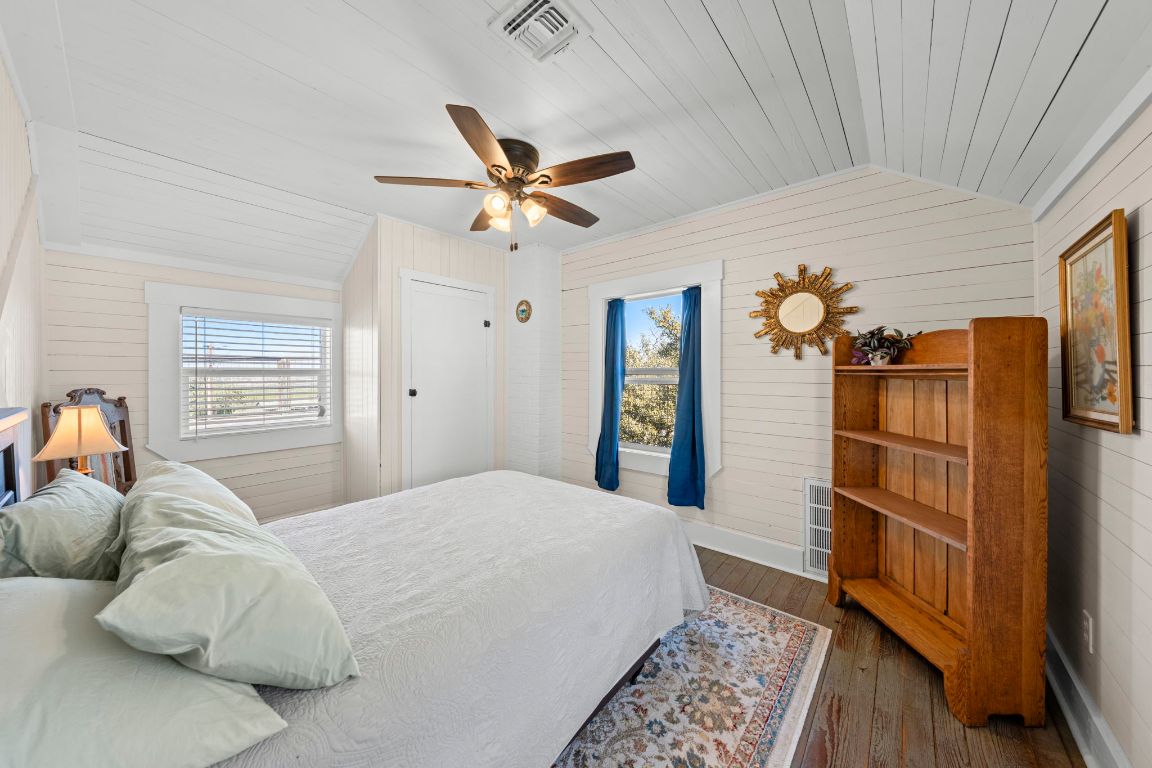 527 Walter Road Fredericksburg, TX 78624 - Photo 21 of 39 a bedroom with a bed and wooden floor