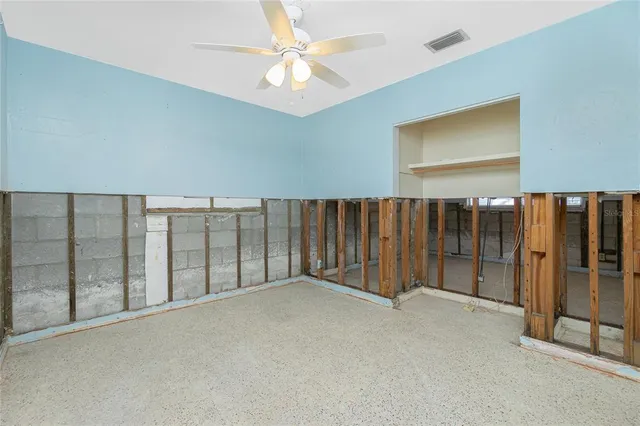 a view of yellow house with large trees