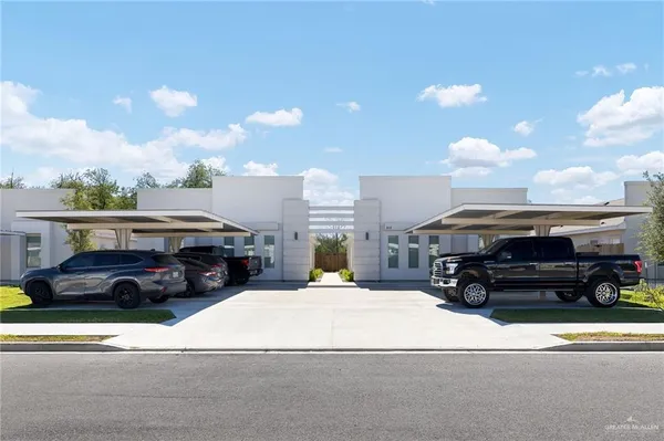 a view of a cars park in front of a building