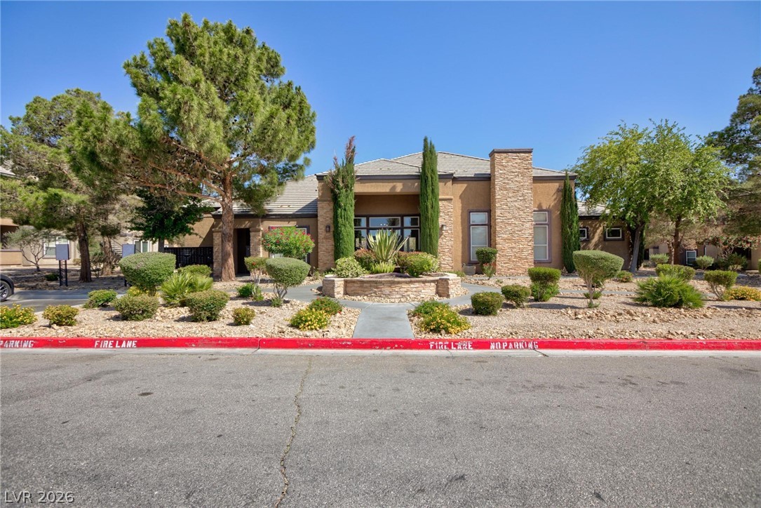 6650 West Warm Springs Road, Unit 2027 Las Vegas, NV 89118 - Photo 2 of 29 This desert-adapted residence presents a welcoming facade amidst thoughtful landscaping and mature trees.