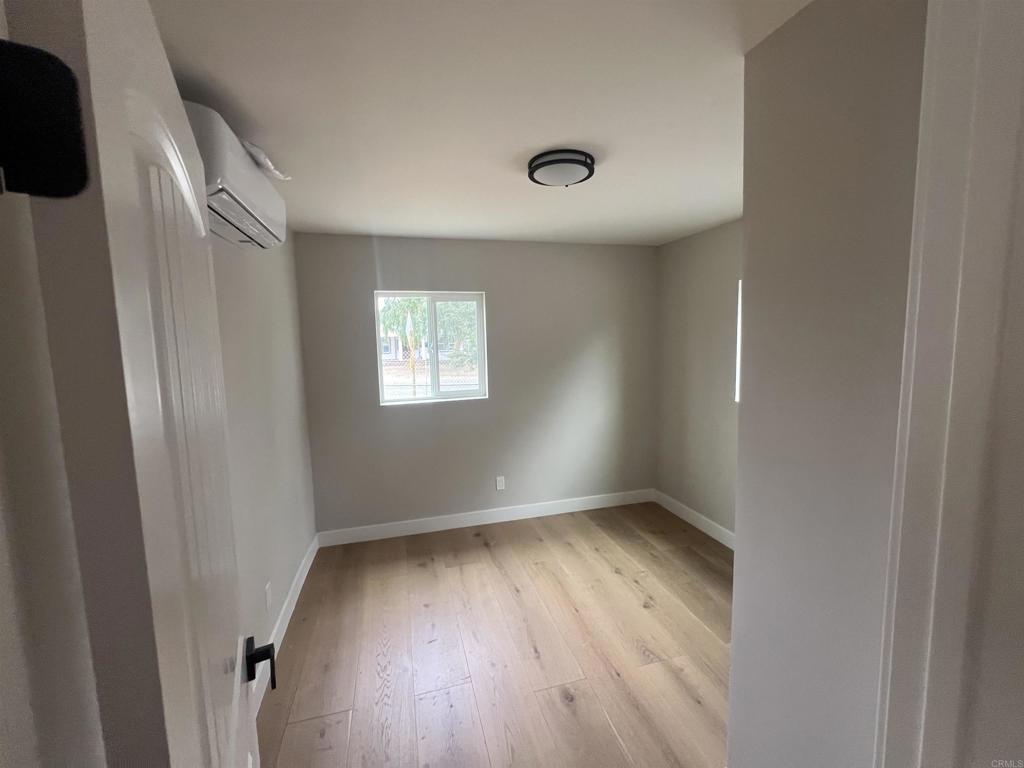 1021 D Street Ramona, CA 92065 - Photo 12 of 27 an empty room with wooden floor and windows