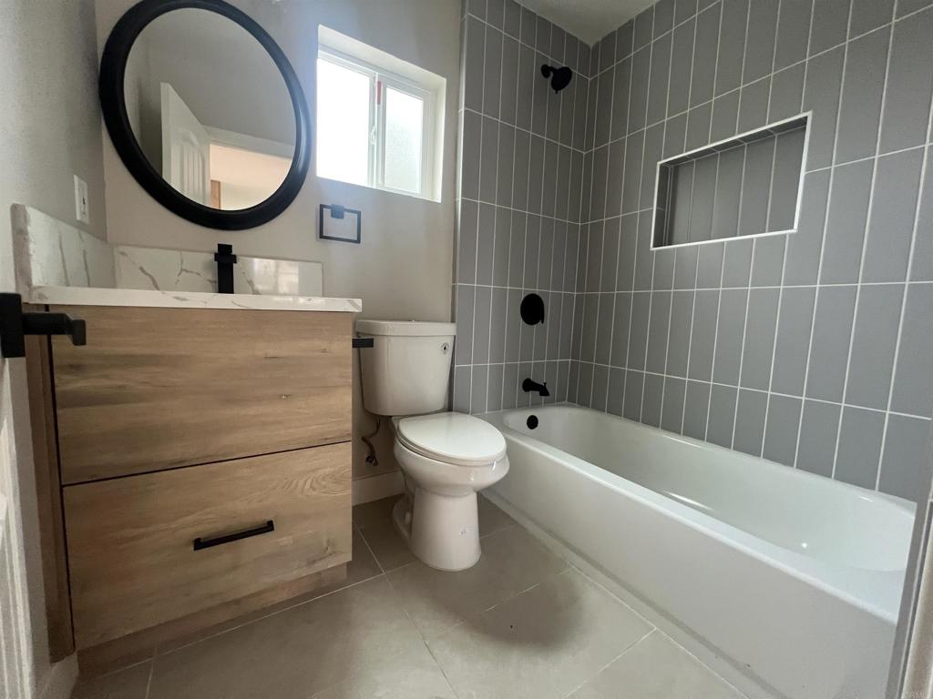 1021 D Street Ramona, CA 92065 - Photo 15 of 27 a bathroom with a toilet a sink and a mirror