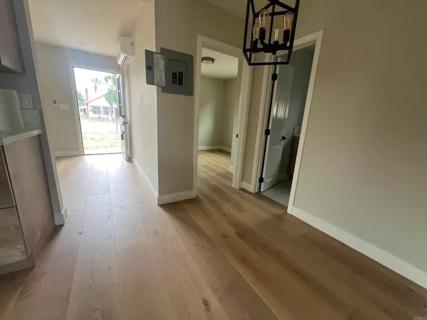 a view of hallway with wooden floor