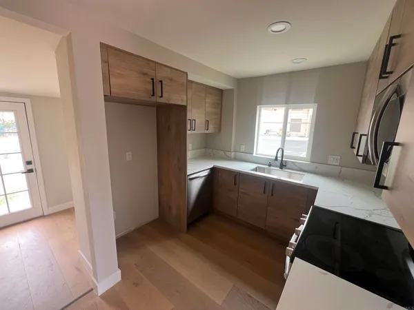 a kitchen with granite countertop a refrigerator and a sink
