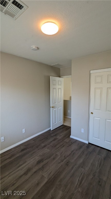 9121 Watermelon Seed Avenue Las Vegas, NV 89143 - Photo 11 of 21 Unfurnished bedroom with dark wood-style floors and baseboards