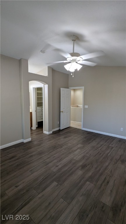 9121 Watermelon Seed Avenue Las Vegas, NV 89143 - Photo 17 of 21 Empty room featuring ceiling fan, dark wood-type flooring, and arched walkways